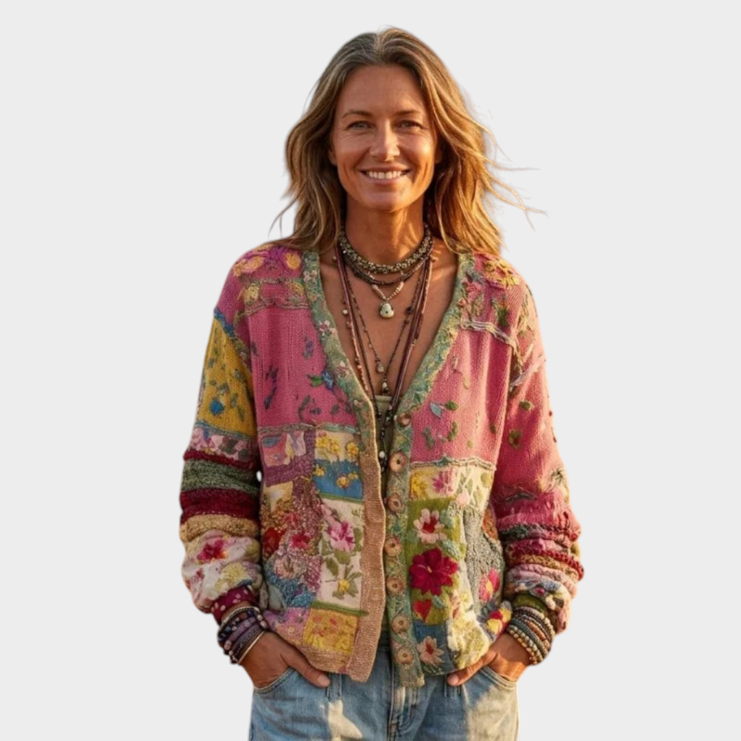 Zane & Inese Zaklina boho cardigan with colorful patchwork floral knit pattern worn by a woman in a field