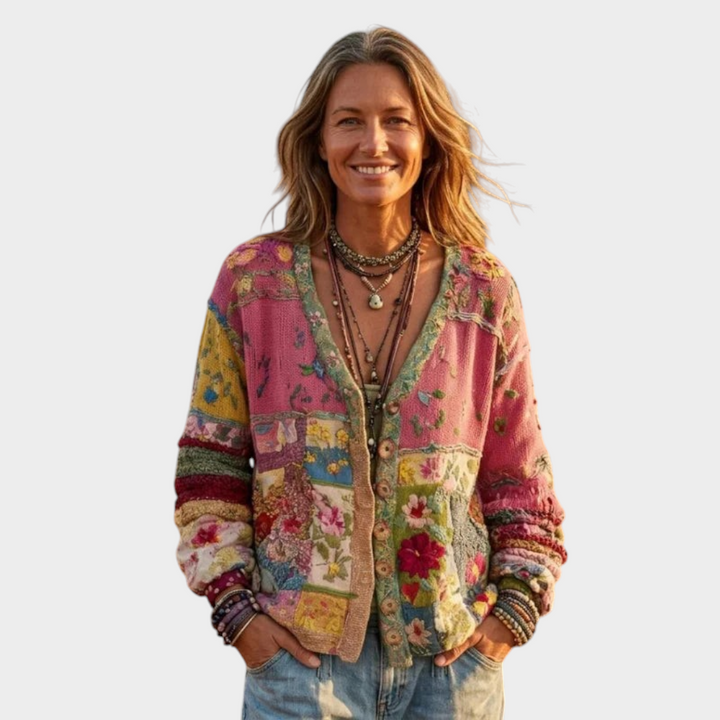 Zane & Inese Zaklina boho cardigan with colorful patchwork floral knit pattern worn by a woman in a field
