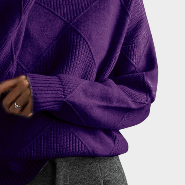 Zane & Inese Gaida purple high-neck sweater featuring a soft knit texture and a modern geometric diamond pattern.