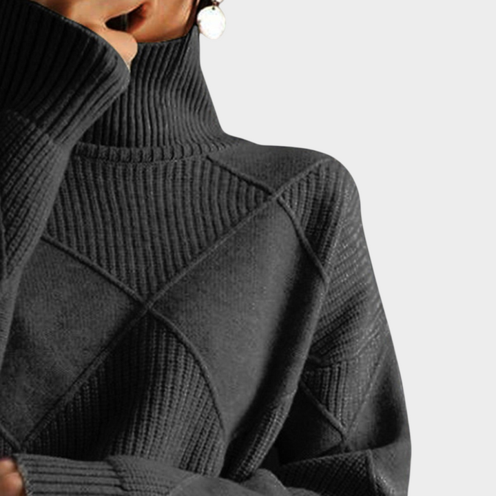 Zane & Inese Gaida charcoal grey high-neck sweater featuring a soft knit texture and geometric pattern details.