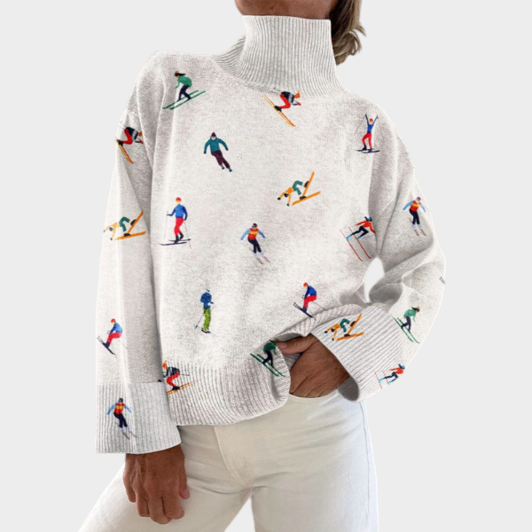 Zane & Inese Karīna white turtleneck sweater featuring a playful colorful skier print and ribbed cuffs.