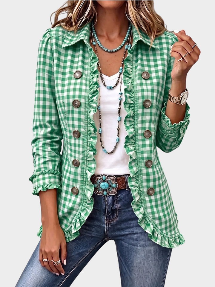 Zane & Inese green gingham plaid jacket with ruffle trim, button closure, and long sleeves worn over a white top.