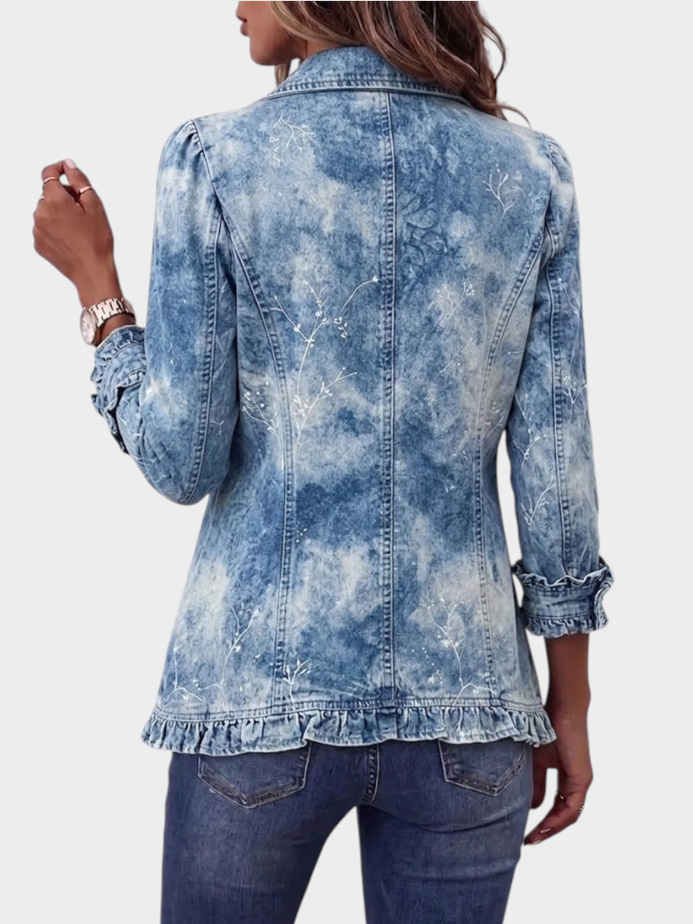 Zane & Inese vintage style denim jacket with botanical print, gradient effect, and ruffled hem, back view.