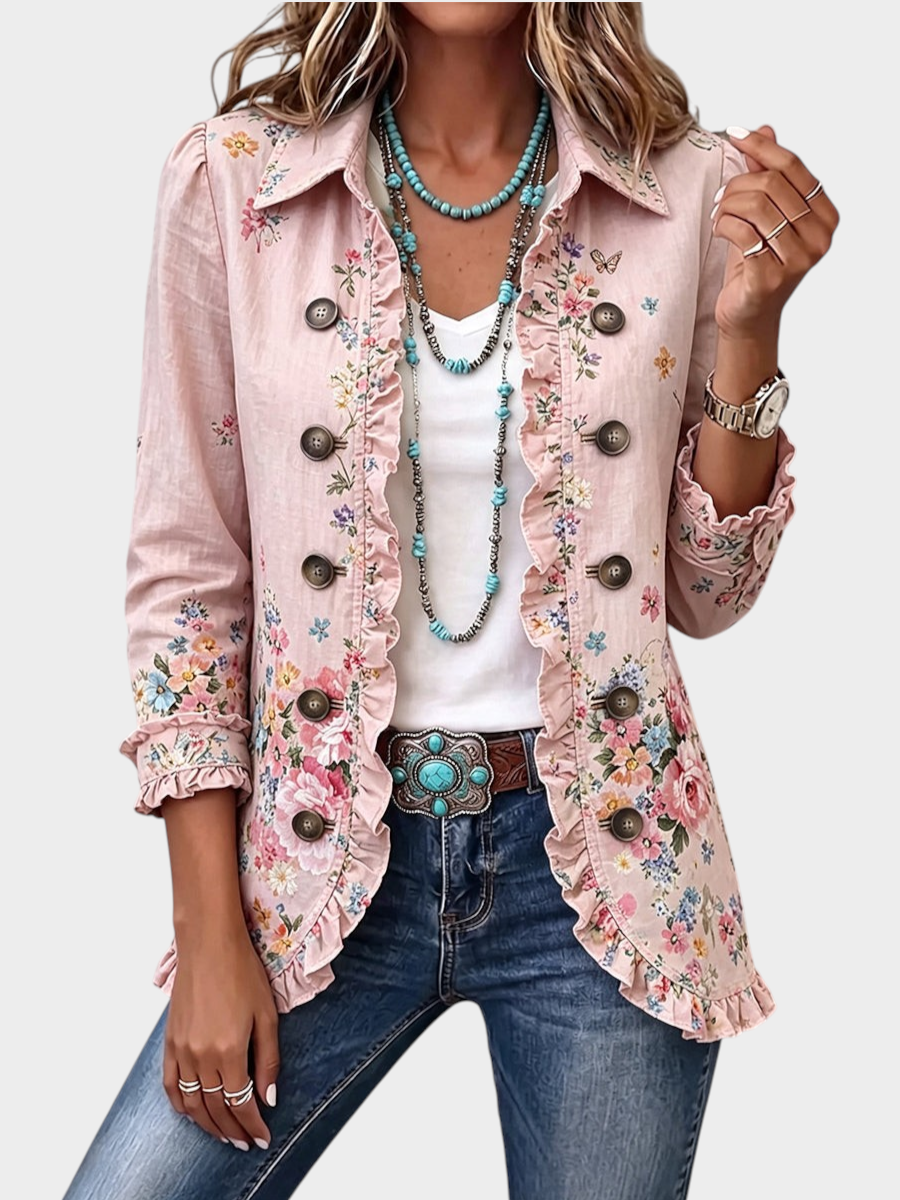 Zane & Inese Aivita floral print cardigan in light pink with ruffled trim, button front, and pointed collar.