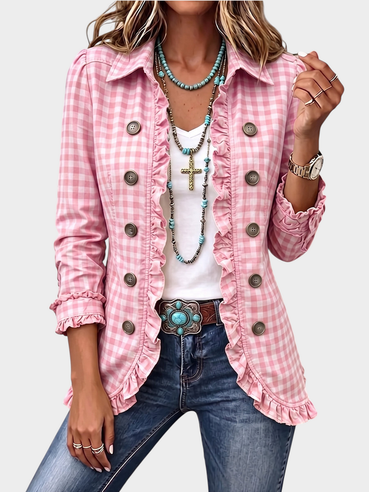 Zane & Inese pink gingham jacket with ruffled trim, double-breasted buttons, and long sleeves on a woman.