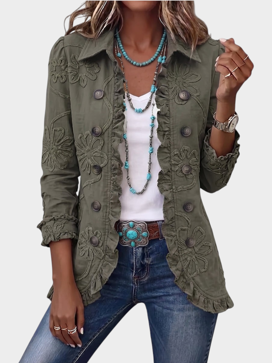 Zane & Inese olive green boho jacket with floral embroidery, ruffled trim, and pointed collar worn over a white top