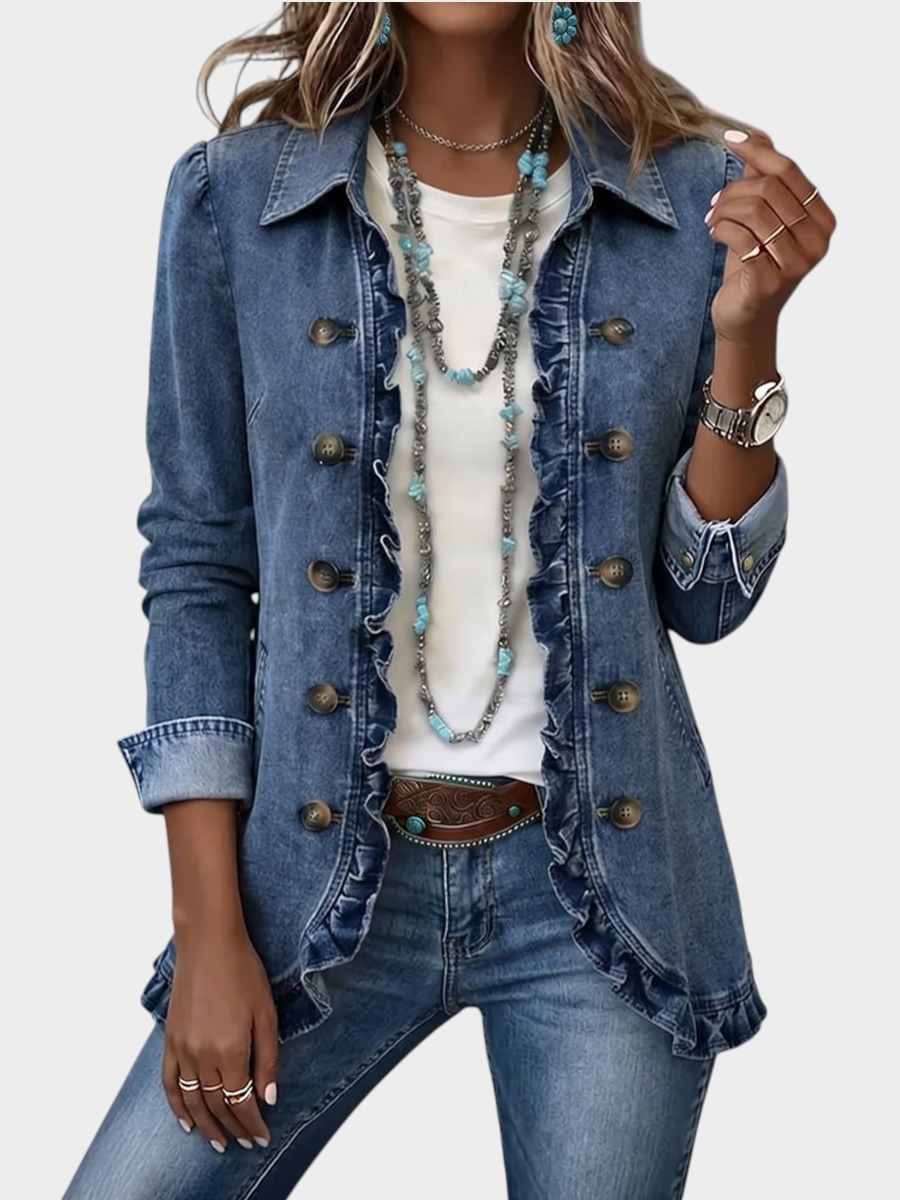 Zane & Inese Spulga denim jacket featuring ruffled trim, vintage buttons, and a pointed collar worn over a white top.