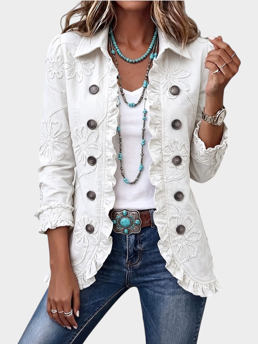 Zane & Inese ivory utility jacket featuring tonal floral embroidery, ruffled trim, and a classic pointed collar.
