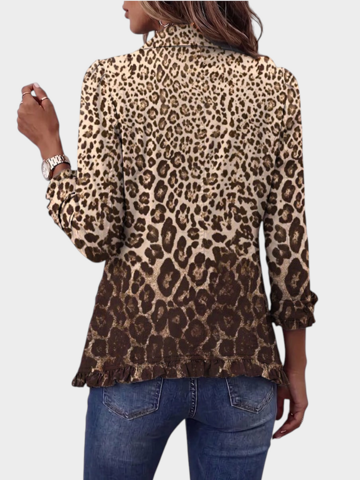 Back view of a Zane & Inese leopard print jacket with a gradient pattern and ruffled hem detail worn with blue jeans.