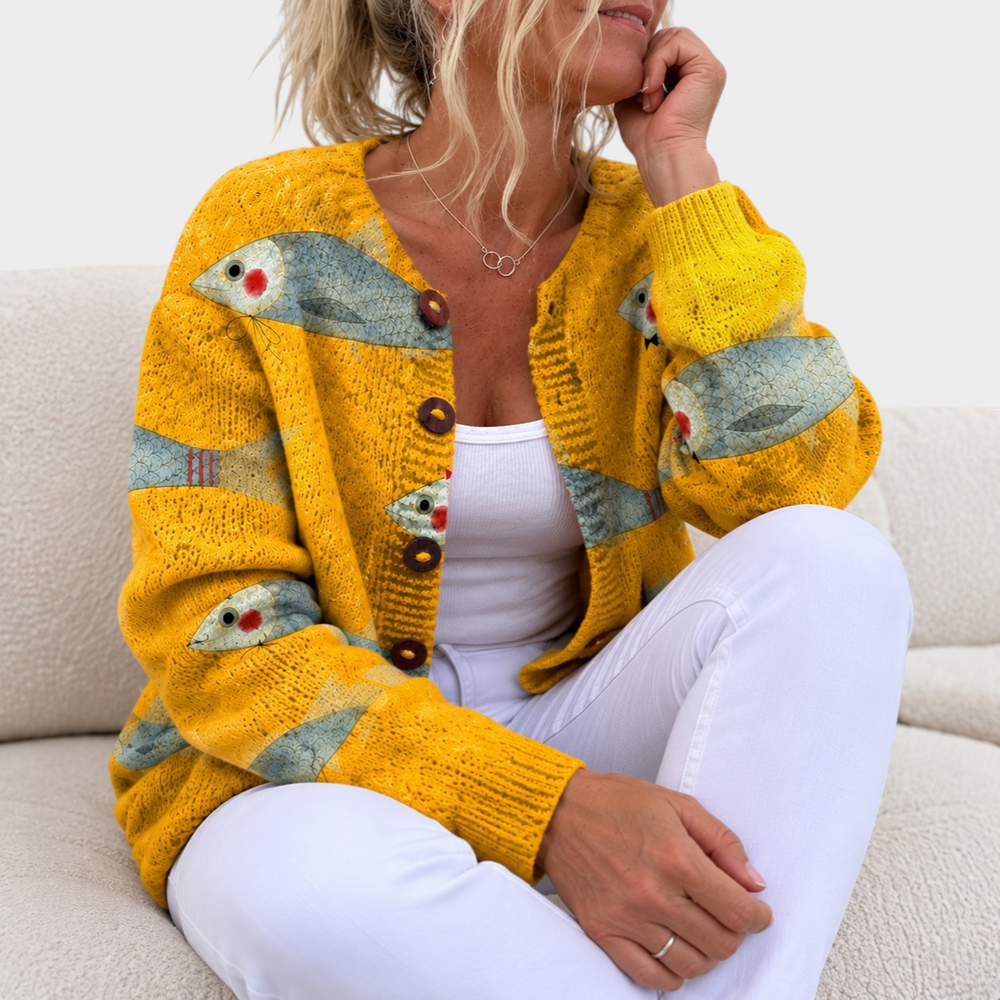 Zane & Inese golden yellow knit cardigan with a unique fish pattern and decorative buttons worn by a woman
