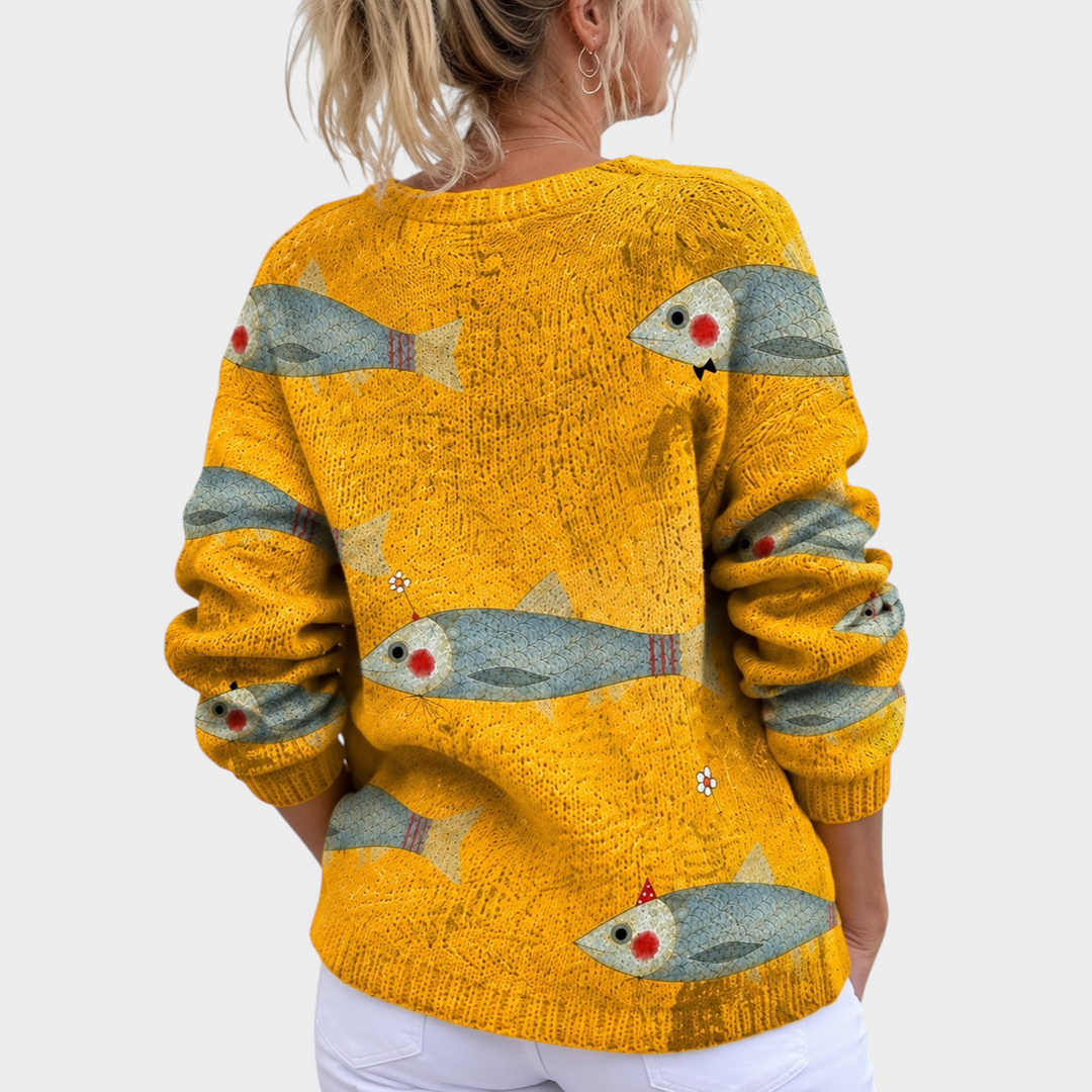 Zane & Inese golden yellow knitted cardigan with a whimsical fish pattern and loose fit, shown from the back.